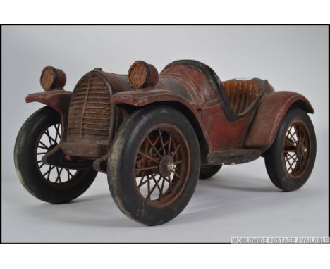 A large 20th century rustic vintage wooden model car with working wheels etc
