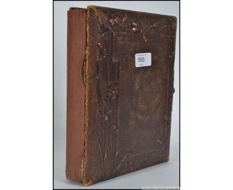 A Victorian leather bound musical photo album having central clasp. The album with some portrait photographs etc