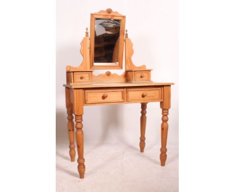 A Victorian style pine duchess dressing table raised on turned legs with drawers having swing dressing mirror atop with trink