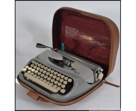 A vintage mid century portable typewriter in the original carry case by Royal