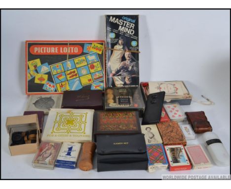 A collection of vintage games to include Picture Lotto, vintage Playing Card decks in packs, a wooden cased Halma, leather ca