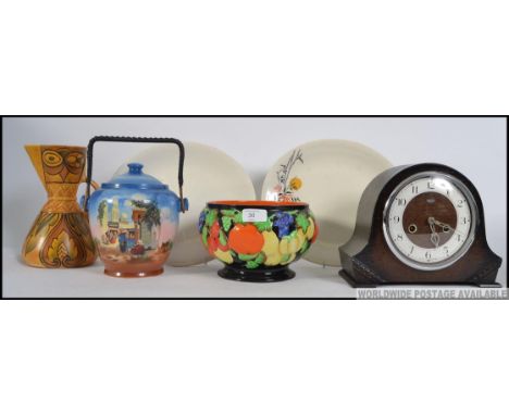 A collection of items to include a hand painted bowl, biscuit barrel, a deco Wade jug, a Smiths mantle clock etc. Measures: 2