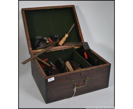 A vintage wooden 20th century tool box with lift up lid revealing a small quantity of wood working tools. Measures: 46cm w.