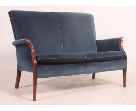 A retro Parker Knoll teak show wood framed sofa of smaller proportions, covered in a rich blue velvet covering. Measure: 82cm