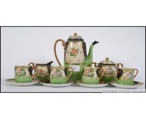 A vintage 20th century Japanese porcelain 4 place tea service complete with the teapot in an unusual colour configuration of 