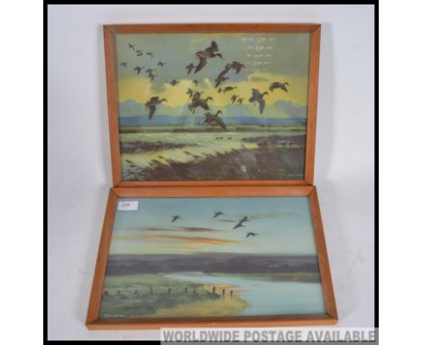 Two vintage 20th century Peter Scott prints of watercolour scenes of marshlands featuring ducks in flight. Both being framed 