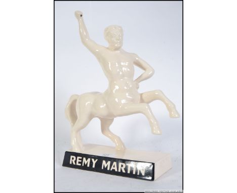   A mid 20th century point of sale continental advertising piece for Remy Martin, the ceramic piece being in the form of a Ce