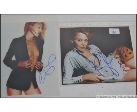 KYLIE MINOGUE; Two 8x10" colour photographs, signed in blue marker by Kylie across a light portion of the images. Come with c