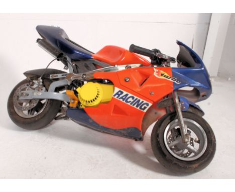 A mini moto motorbike with engine etc  ( sold untested ). Measures: 100cm L.