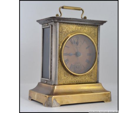 A brass musical  carriage clock, having a chase decorated panel, roman numeral chapter ring with subsiduary dials, capital B 