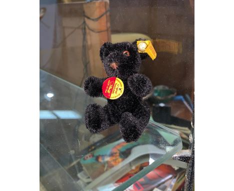 A STEIFF black fur miniature jointed bear 10cm 