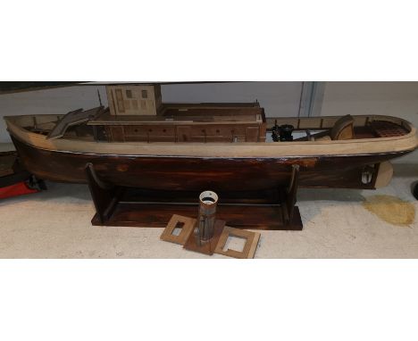 A part built tug boat with engine 