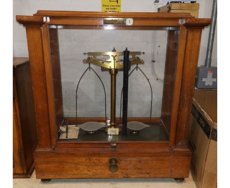 A set of two pan laboratory scales by Oertling, glazed mahogany case, a boxed set of weights 