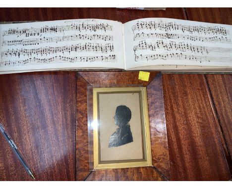 A 19th century manuscript of music inscribed Mr Moorhouse's; a 19th century silhouette in burrwood frame