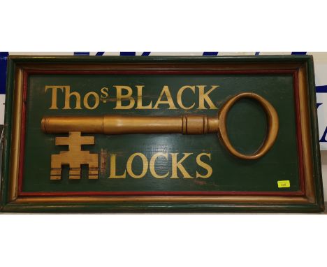 A vintage wooden sign Tho.s Black Locks decorated with key in relief 