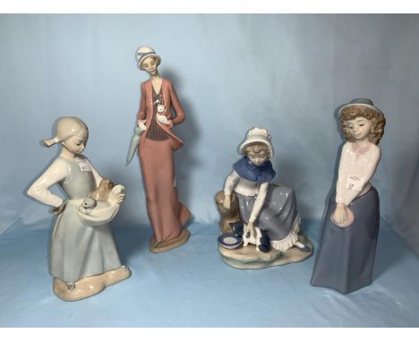 4 Nao figures - girl in hat, girl feeding kitten, girl with kitten 