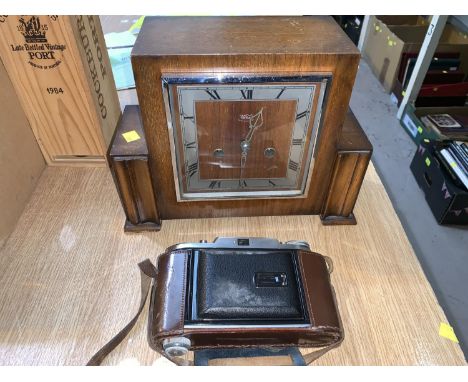 A 1930's Voightlander camera in leather case; an Art Deco oak chiming mantle clock 