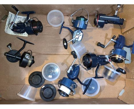 A collection of 7 vintage Mitchell reels plus spare spools, containers etc 