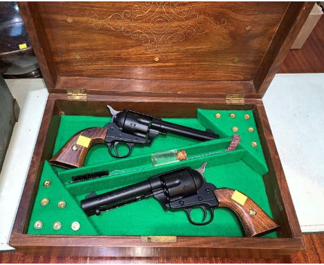 A pair of replica display model "Single Action Army 45" revolver in fitted brass inlaid hardwood box