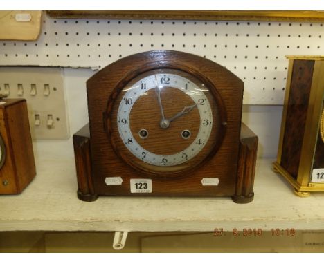 An oak mantle clock