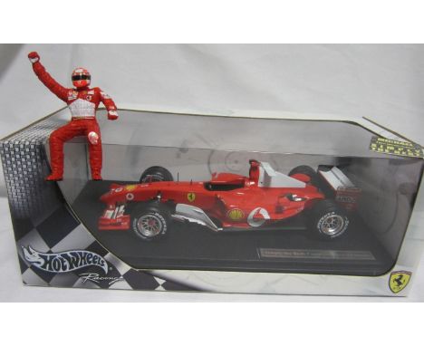 F1 MODEL CARS - MICHAEL SCHUMACHER       Issued by Hot Wheels, 1:18 scale Ferrari F2004 - 2004 seven times F1 Champion Specia