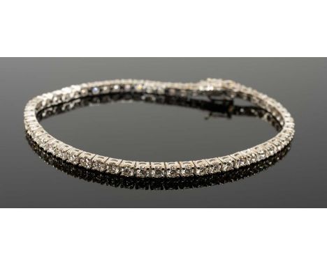 18CT WHITE GOLD DIAMOND LINE / TENNIS BRACELET, set with 56 round cut diamonds, 3.0-3.5cts overall approx., stamped '750', 17