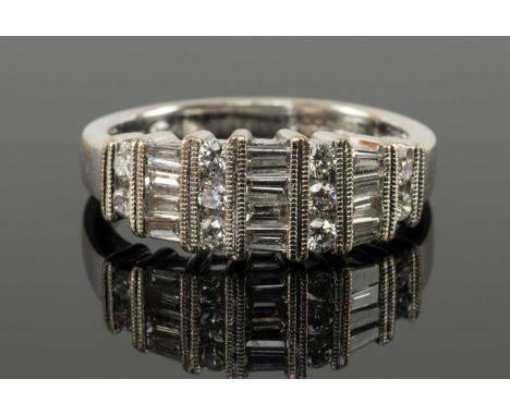 18CT WHITE GOLD DIAMOND RING, the baguette and brilliant cut stones in mille grain alternate column settings, 4.6gProvenance: