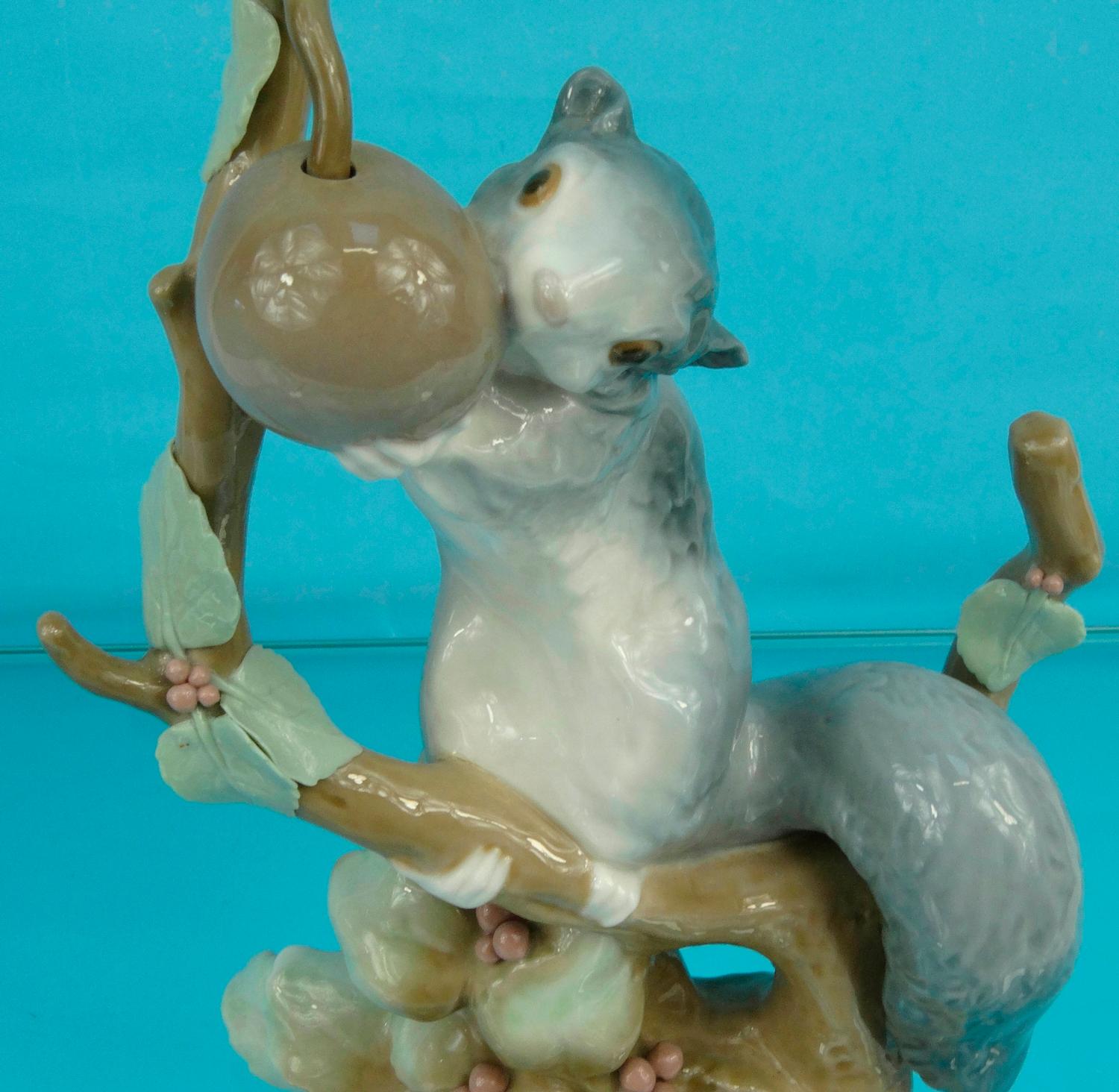 Lladro figure of a squirrel eating an acorn on a branch, 23cm high ...