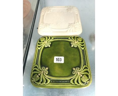 A Poole Pottery Carter & Co. green glazed teapot stand together with another.