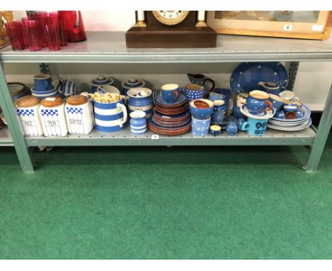 A shelf containing a very large quantity of T. G. Green blue and white banded Cornish kitchenware items together with a set o