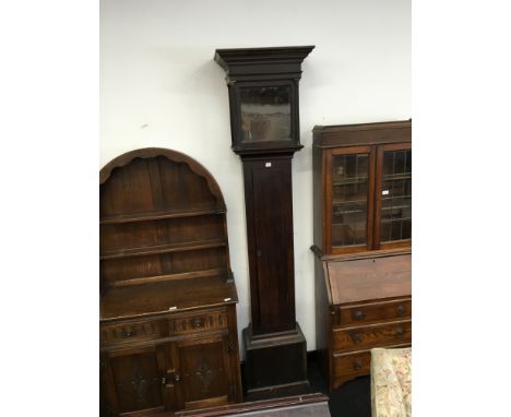 A Georgian mahogany longcase clock case fitted an elongated single door, over hanging cornice and four pillar supports.