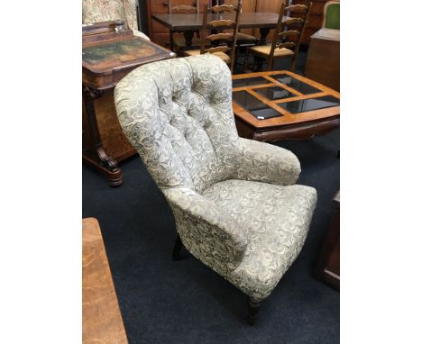 A Victorian occasional chair of 'U' shape form, padded button back, resting on turned front legs, upholstered in green Damask