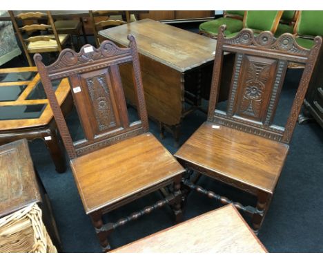 A pair of carved Restoration design oak dining room chairs with bobbin twist supports and legs.