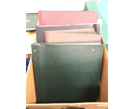 A box containing various stamp albums and contents.