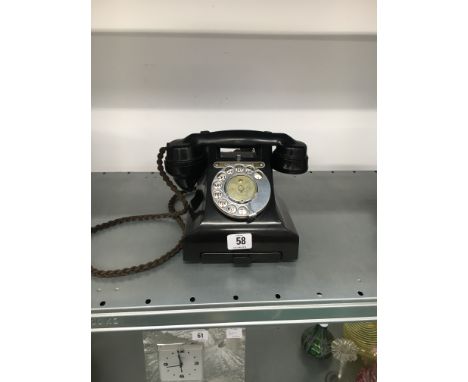 An early 20th century black cased telephone handset, No. 312L S52/3A with Directory drawer and Call Exchange button.