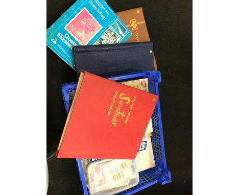 A box containing various stamp albums and contents