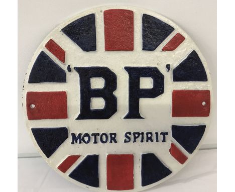 A cast iron circular shaped BP wall hanging plaque, painted in red, white and blue colours. With fixing holes. Approx. 24.5cm