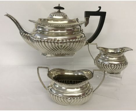 An Edwardian antique silver tea set with classic style decoration. Comprising: teapot, two handled sugar bowl and a milk jug.