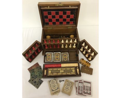 A late 19th century fitted games compendium, possibly by Goodhall &amp; Son. Fully complete, including 1 unopened set of play