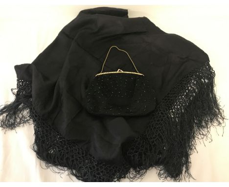 A black silk evening scarf with fringed ends together with a vintage beaded evening bag.