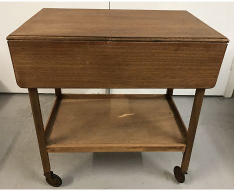 A vintage wooden drop leaf tea trolley with under shelf. Approx. 69cm tall.