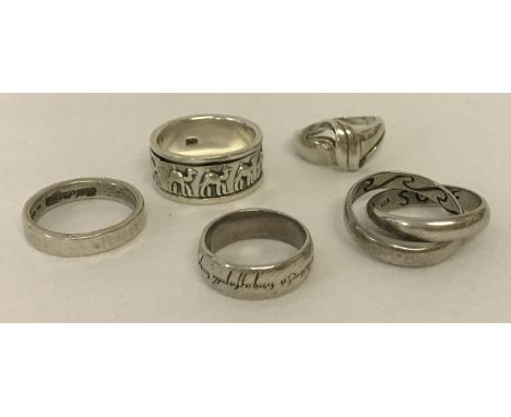 5 decorative silver band rings all marked 925. Comprising: Twisted silver knot (has been cut), 2 intertwining rings with Sun,