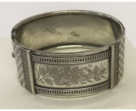 A vintage white metal bracelet with checkerboard and floral engraved panel decoration. Safety chain missing.