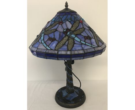 A tiffany style table lamp with leaded glass shade and lamp base. Dragonfly detail to shade and base. Approx. 58cm tall.