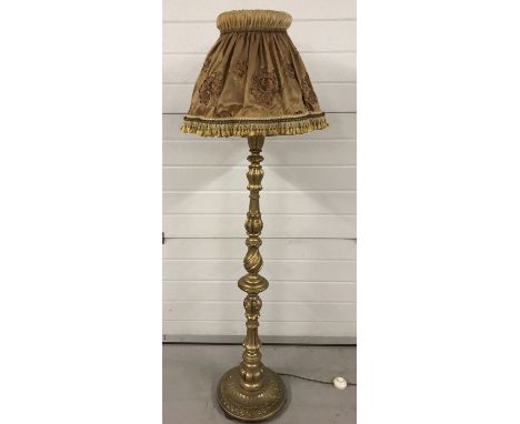 A vintage wooden gilt painted standard lamp with highly turned pedestal, complete with vintage shade