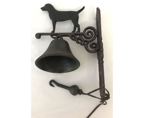 A wall hanging cast iron garden bell with dog detail. With fixing holes. Approx. 34cm long.