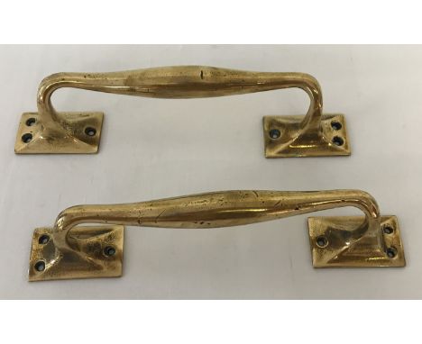 A pair of antique brass door handles. With 3 fixing holes to each bracket. Approx. 28cm long.