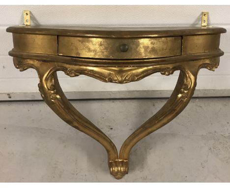 A vintage style gilt wall mounted table/shelf with central drawer. Approx. 58cm wide x 56cm tall.