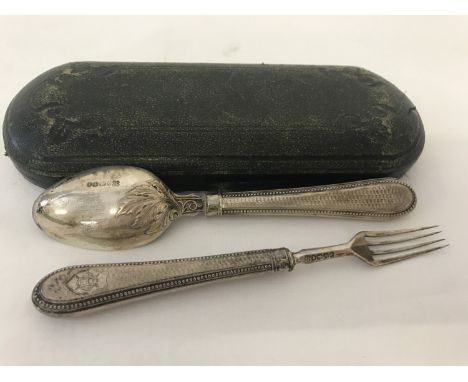 A Victorian silver spoon and matching fork in original case. Engine turned decoration to handles with initialled cartouche. L