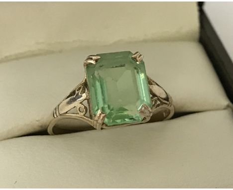 A 9ct gold dress ring, set with a octagon cut light green stone. Ring size O. Total weight approx. 2.1g.